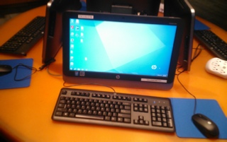 Computer on round orange desk